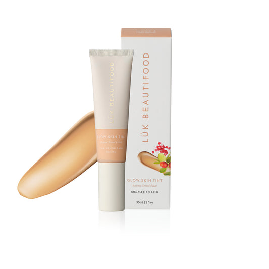 LÜK Beautifood Instant Glow Skin Tint in Nude 3 Light Medium, tube and box with a swatch of the tinted complexion balm