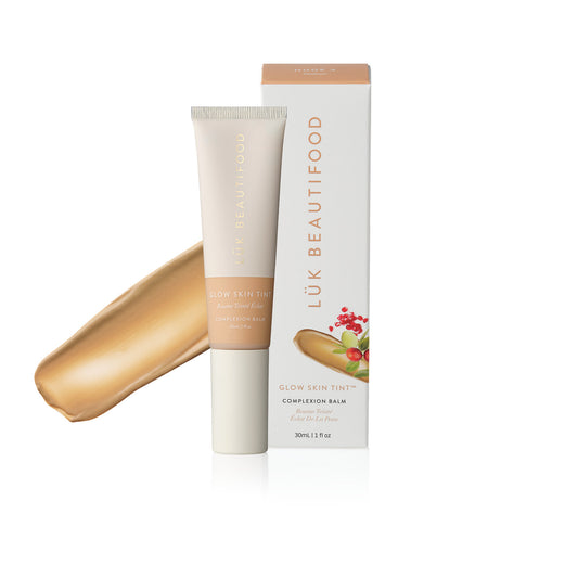 LÜK Beautifood Instant Glow Skin Tint in Nude 4 Medium, tube and box with a swatch of the tinted complexion balm