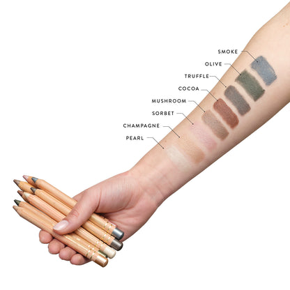 All eight Lük Beautifood Luminous Eye Crayon shades swatched on the arm: Pearl, Champagne, Sorbet, Mushroom, Cocoa, Truffle, Olive, Smoke